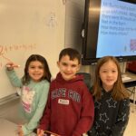 boy and two girls doing math problem