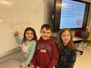 boy and two girls doing math problem
