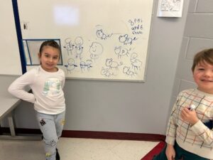 girl posing next to math problem on white board