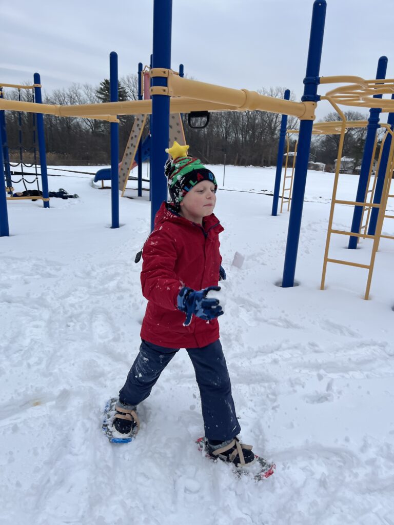 student walking through snow