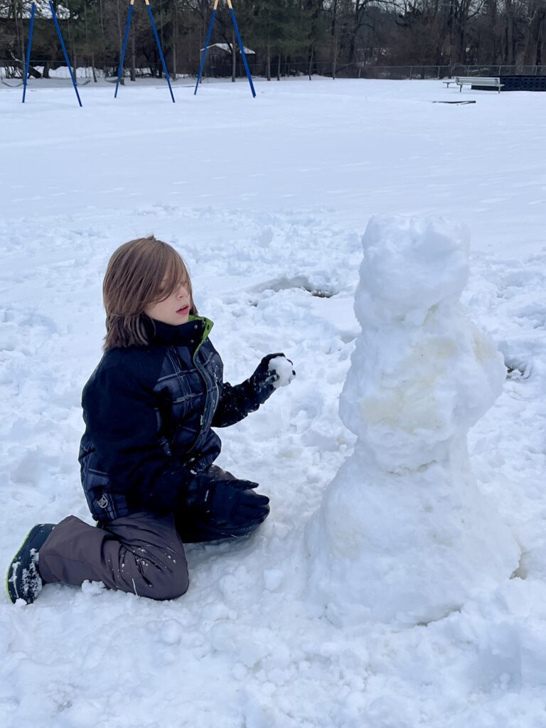 student making snowman