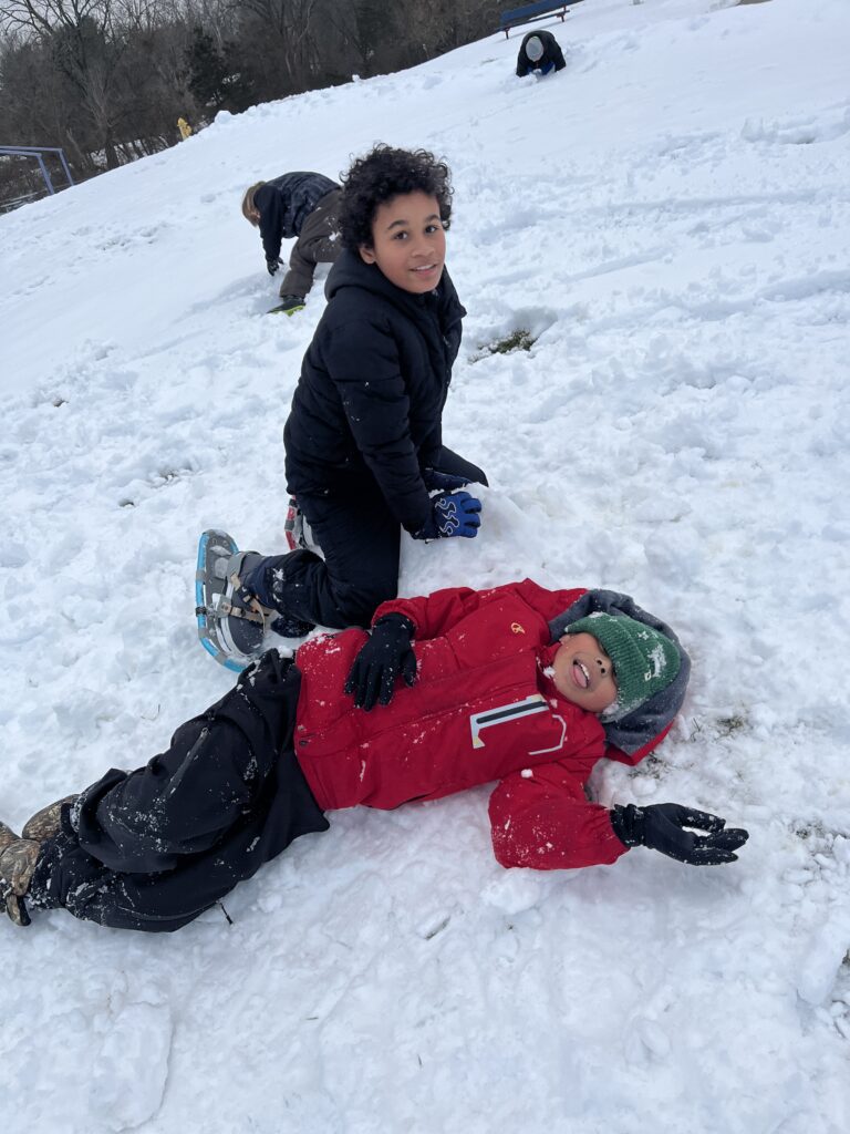 students playing in snow