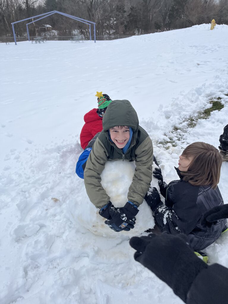 students playing in snow