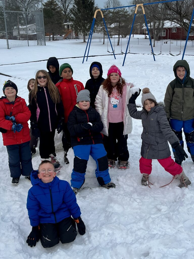 group photo of students on snowy playground