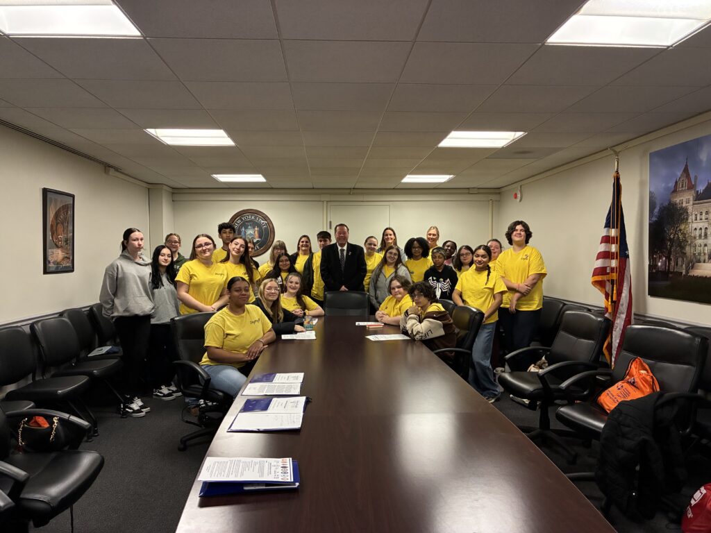 students pose for photo with assemblymember Tague