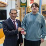 boy shaking principal's hand