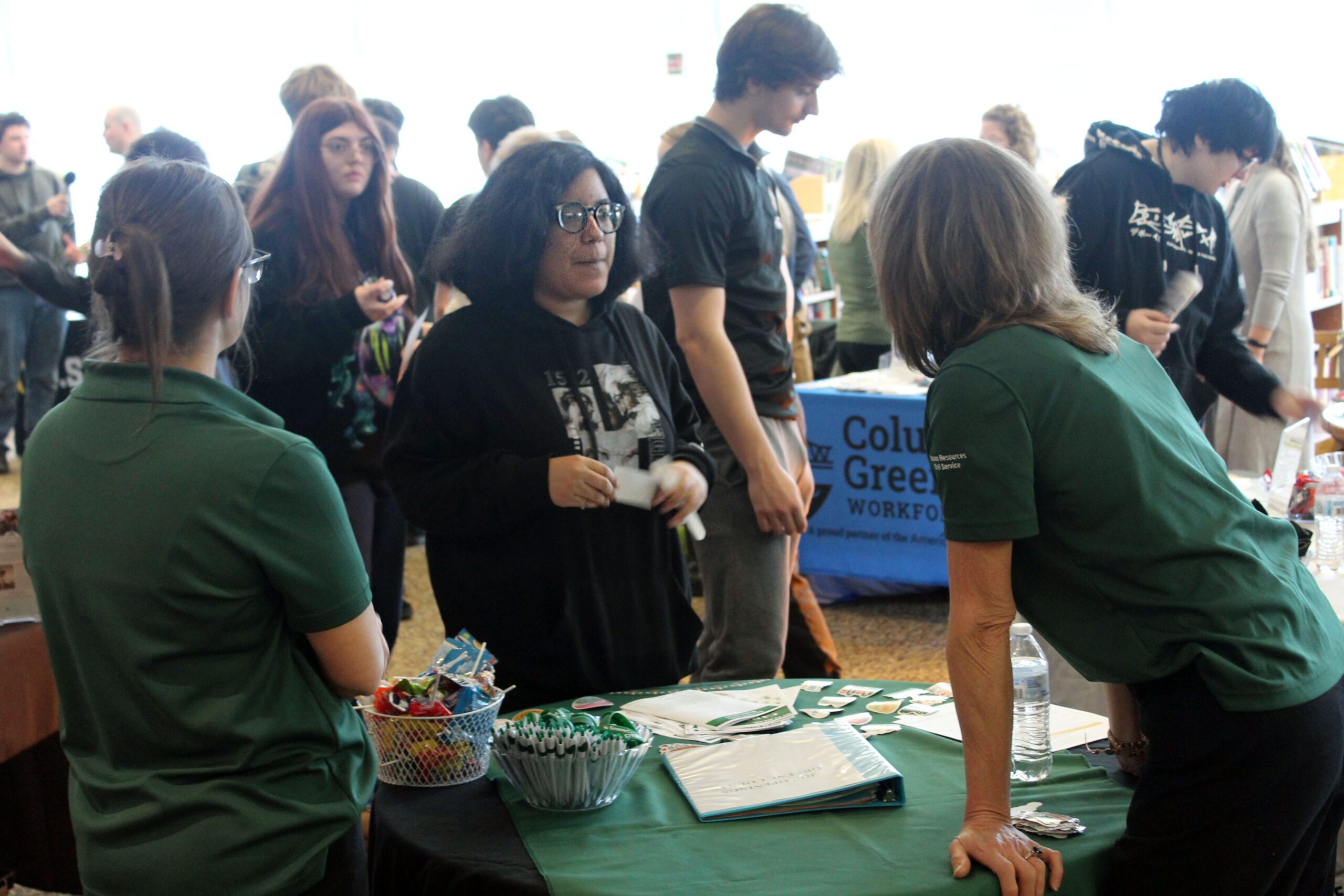 girl chatting with woman at job booth