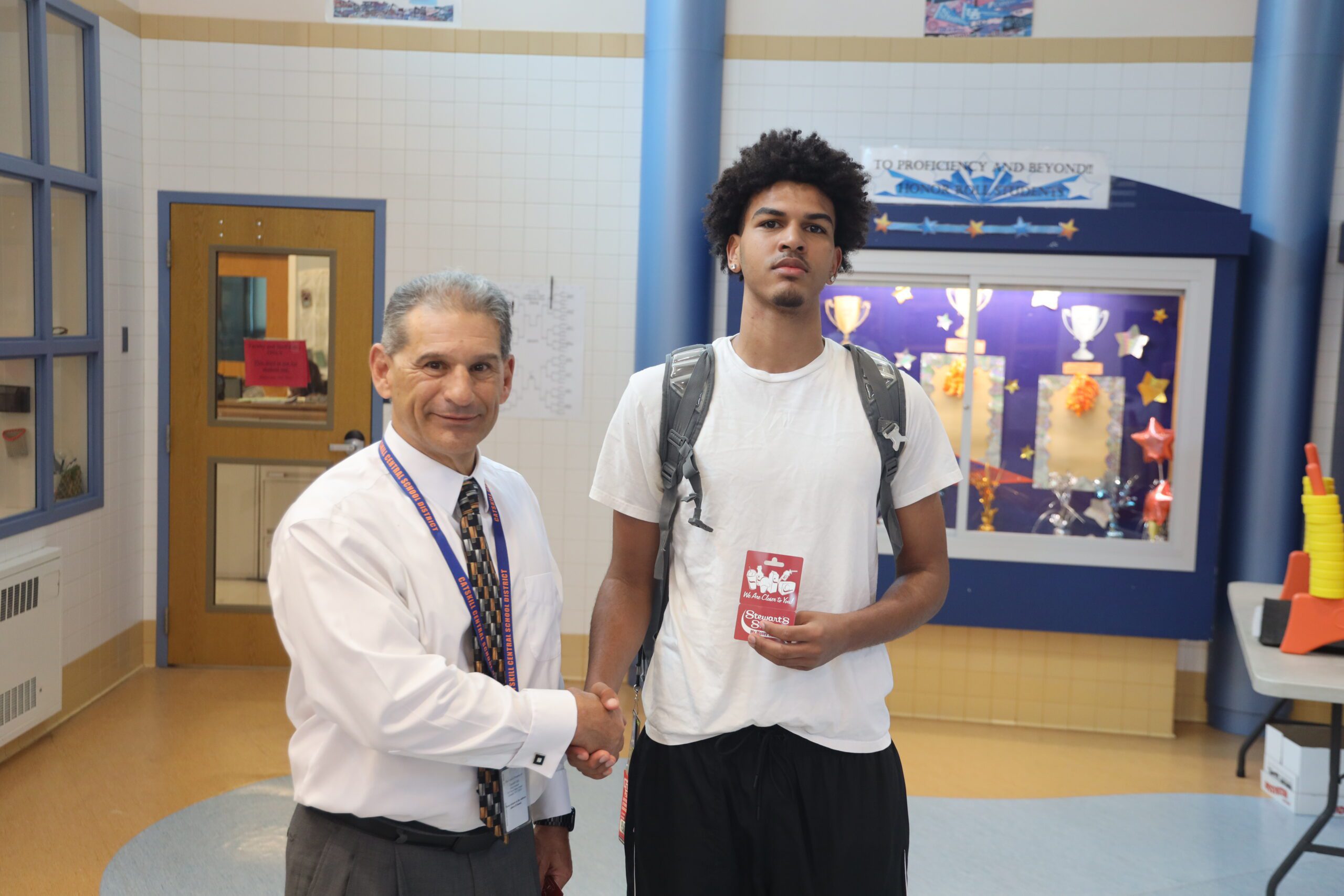 man shaking teenage boy's hand