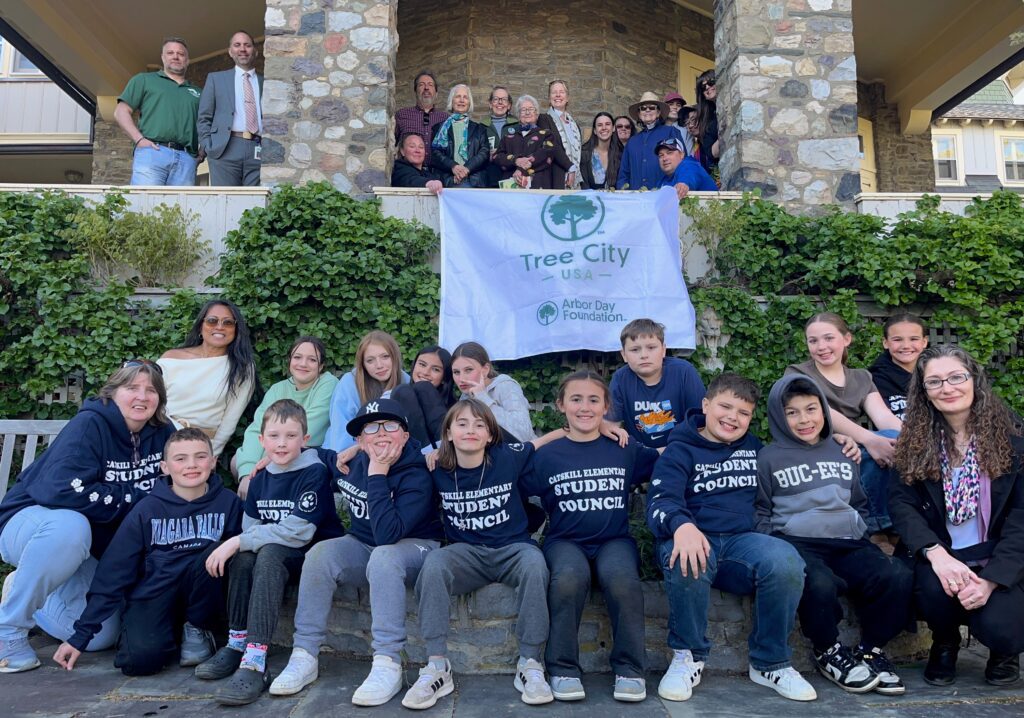 student council students pose for photo wearing Arbor Day t-shirts