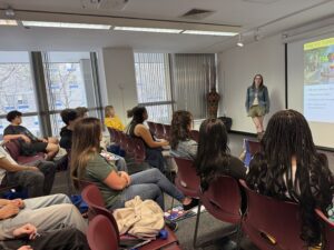 woman talking to group of seated students