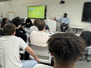 man talking to group of students