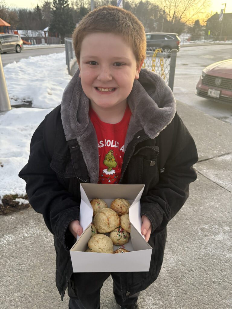boy with box of baked goods