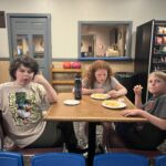 students eating snacks at table