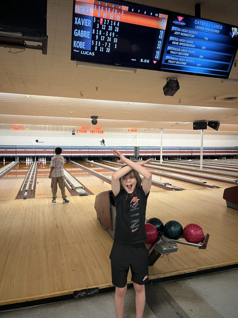student celebrating good bowling