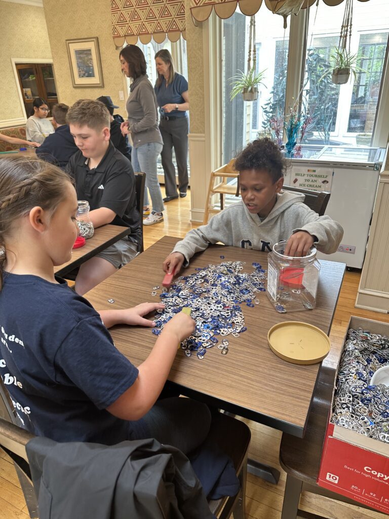 two students counting tabs on tables