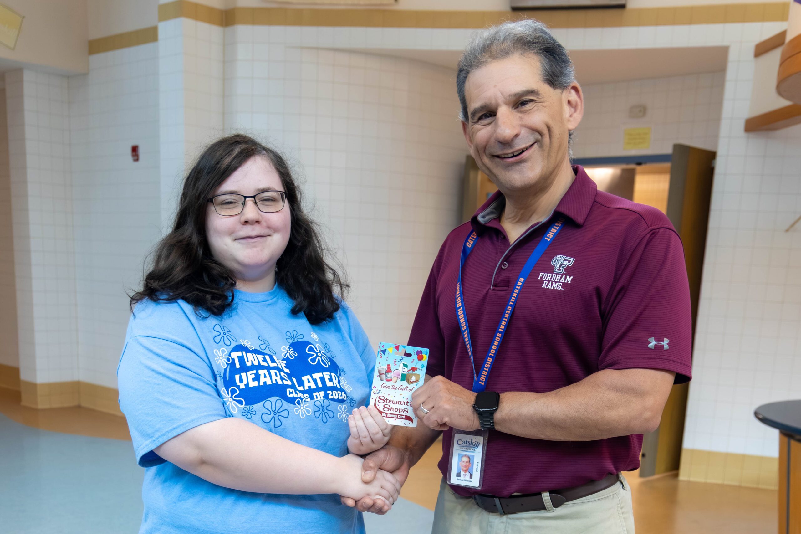 girl accepting award from principal 