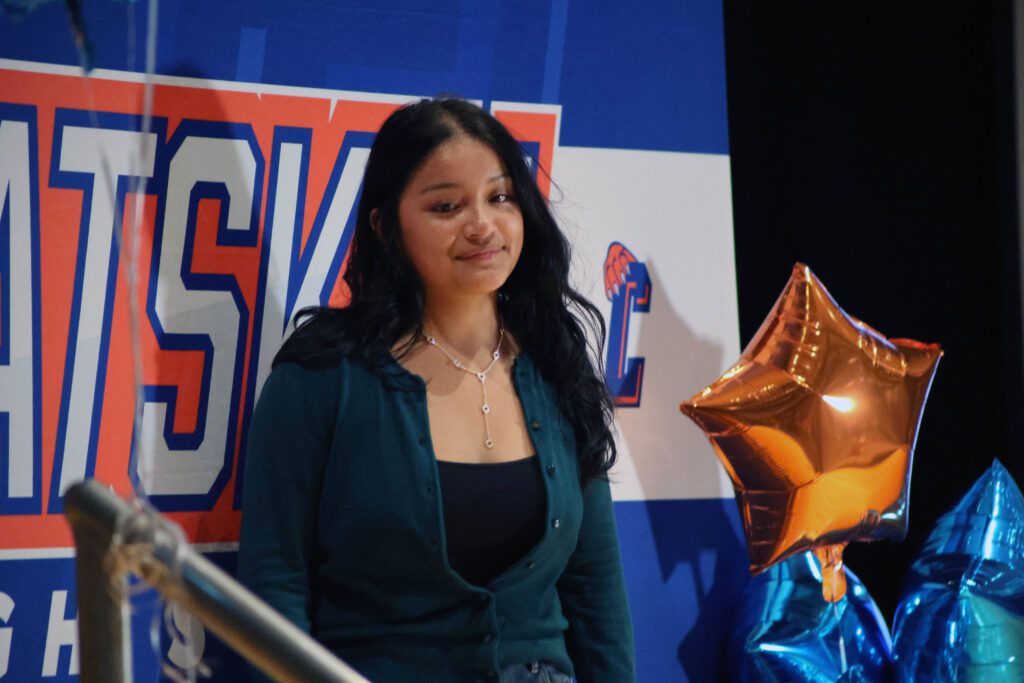 girl poses for picture in front of Catskill High School backdrop