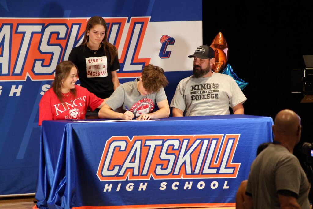 young man signing letter of intent