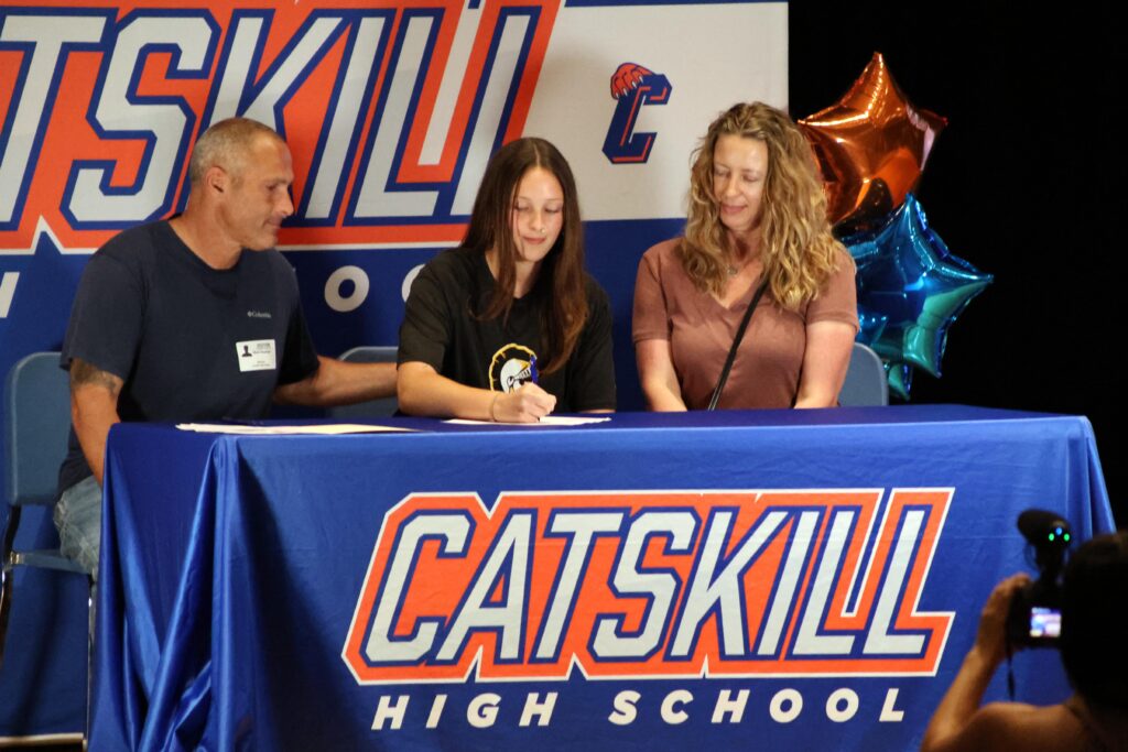 young woman signing letter of intent