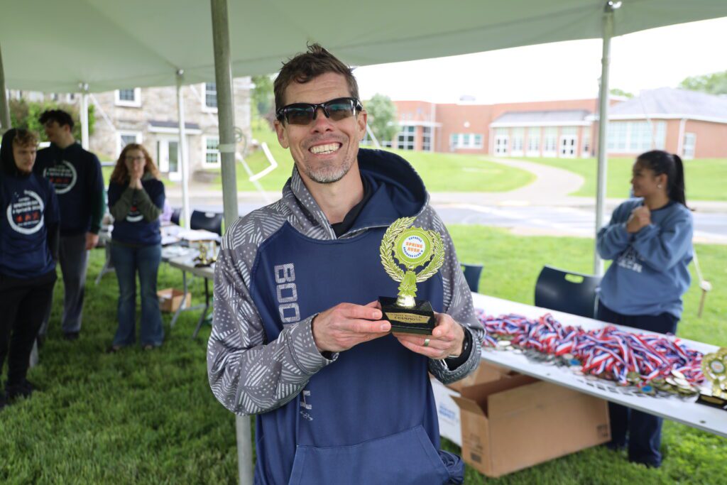 man holding trophy