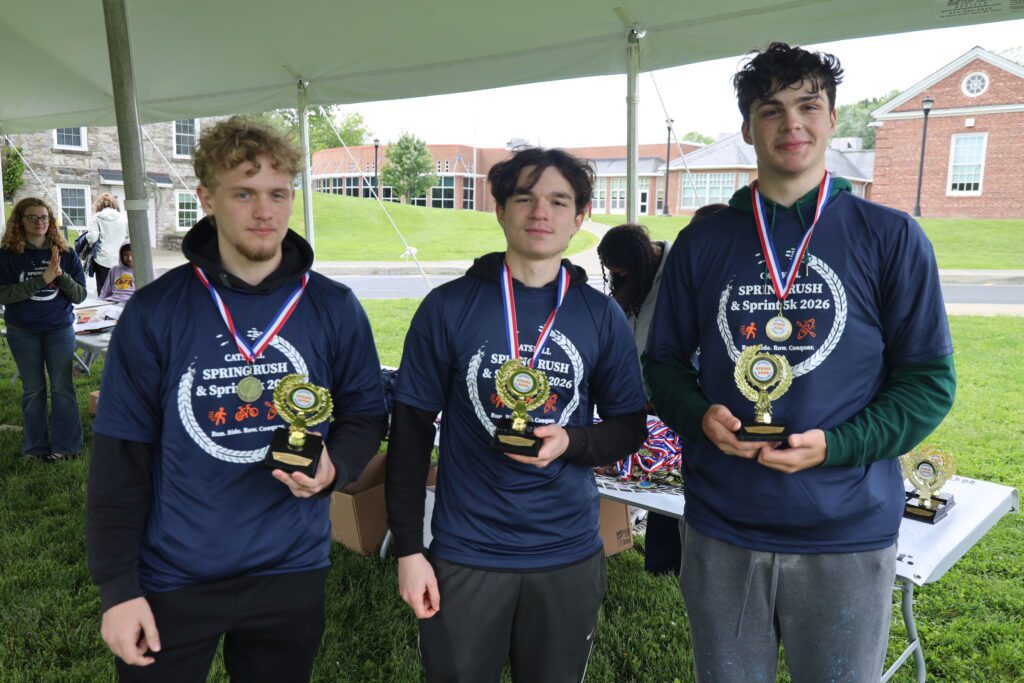 three young men wearing medals