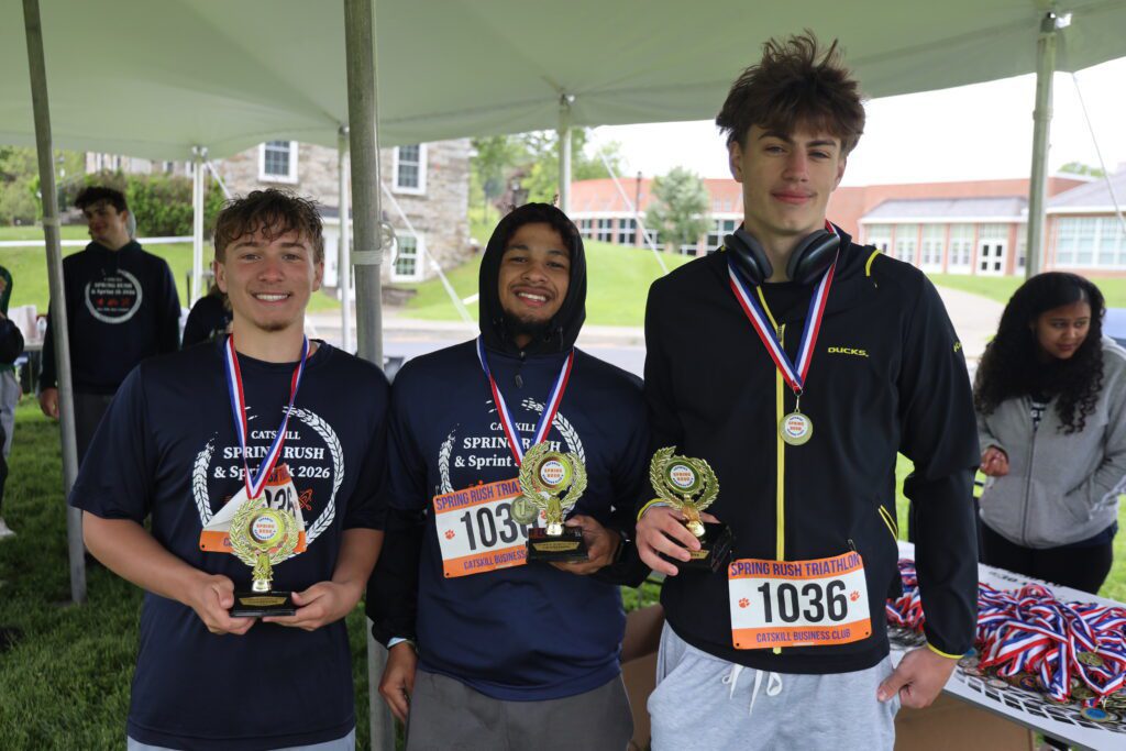 three young men wearing medals