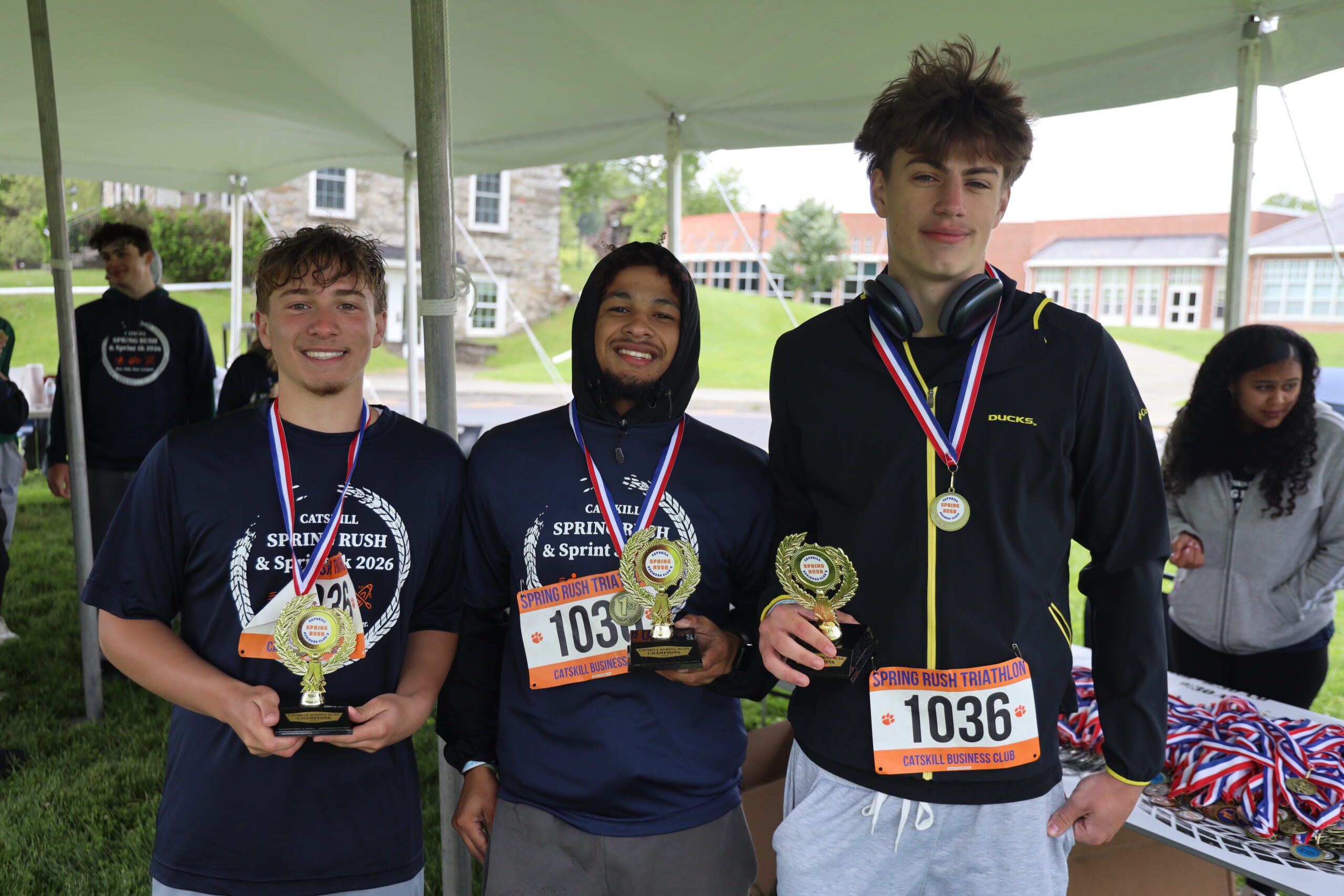 three young men wearing medals
